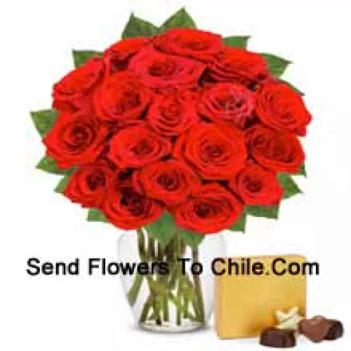 25 Red Roses With Some Ferns In A Glass Vase Accompanied With An Imported Box Of Chocolates