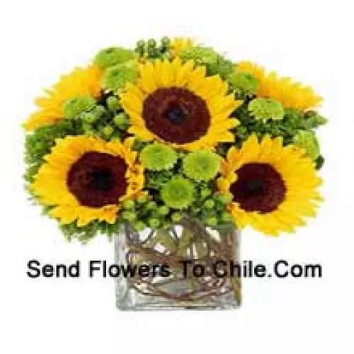 Sunflowers With Suitable Seasonal Fillers Arranged Beautifully In A Glass Vase