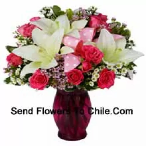 Pink Roses And White Lilies With Seasonal Fillers In A Glass Vase