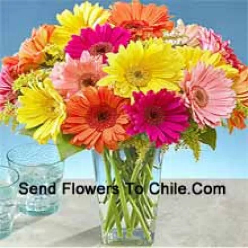 25 Mixed Colored Gerberas With Some Ferns In A Glass Vase