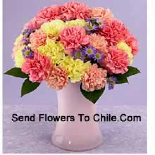 25 Mixed Colored Carnations With Seasonal Fillers In A Glass Vase