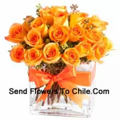 25 Orange Roses With Some Ferns In A Glass Vase